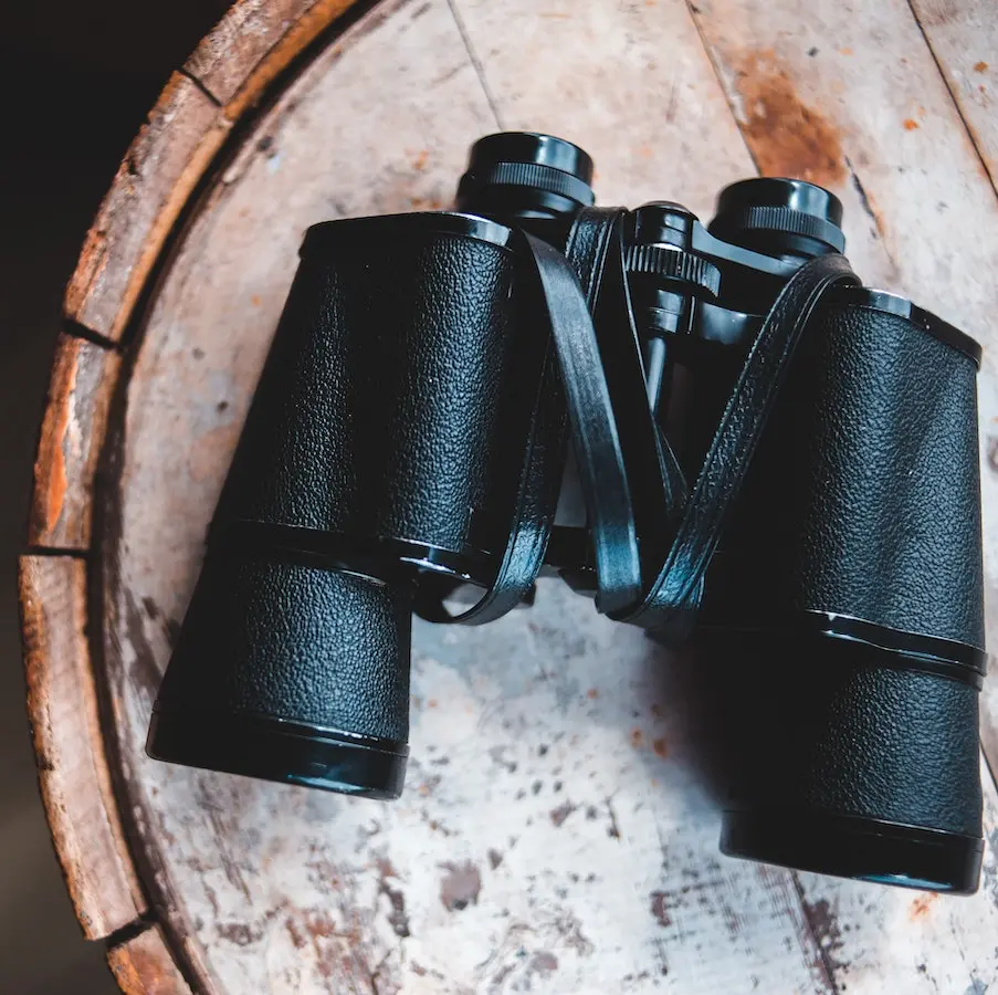 Binoculars on wood table